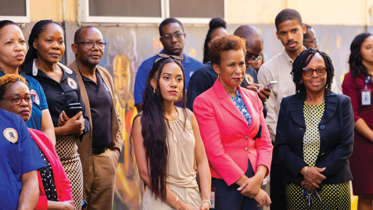 Members of the Bank of Jamaica team together with mural artist